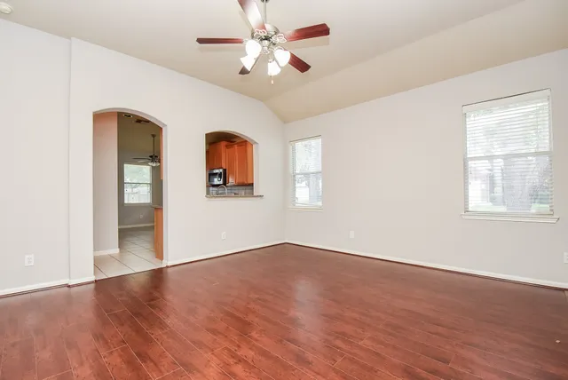 wooden floor in an empty room with a window