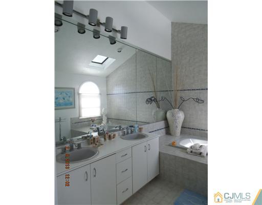 6 Valarie Road Edison, NJ 08820 - Photo 13 of 23 a bathroom with a sink and a mirror