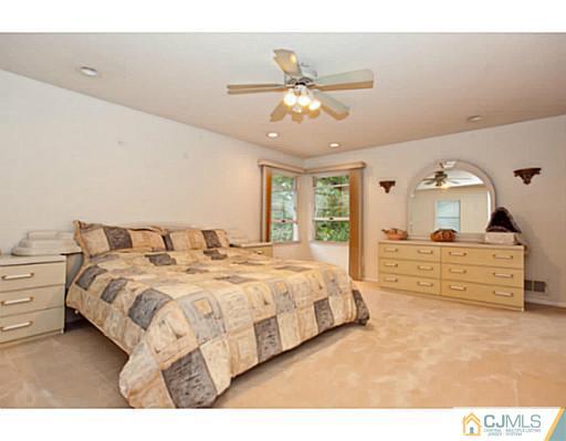 6 Valarie Road Edison, NJ 08820 - Photo 14 of 23 a spacious bedroom with a bed and a dresser
