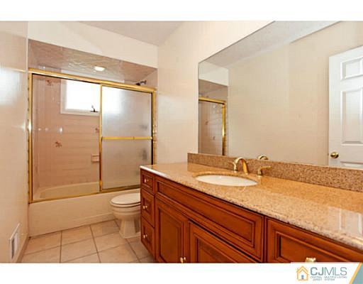 6 Valarie Road Edison, NJ 08820 - Photo 15 of 23 a bathroom with a granite countertop sink toilet mirror and shower