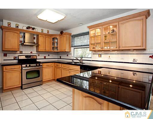 6 Valarie Road Edison, NJ 08820 - Photo 4 of 23 a kitchen with stainless steel appliances a sink stove and cabinets