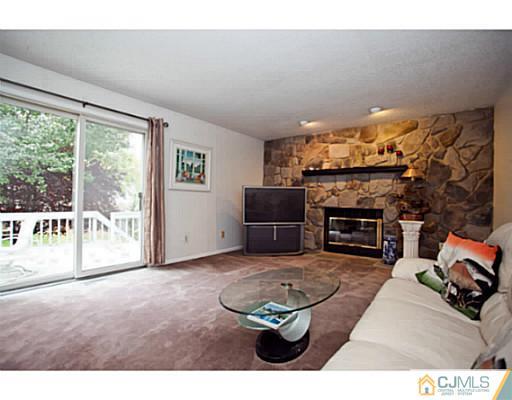 6 Valarie Road Edison, NJ 08820 - Photo 9 of 23 a living room with furniture a fireplace and a flat screen tv