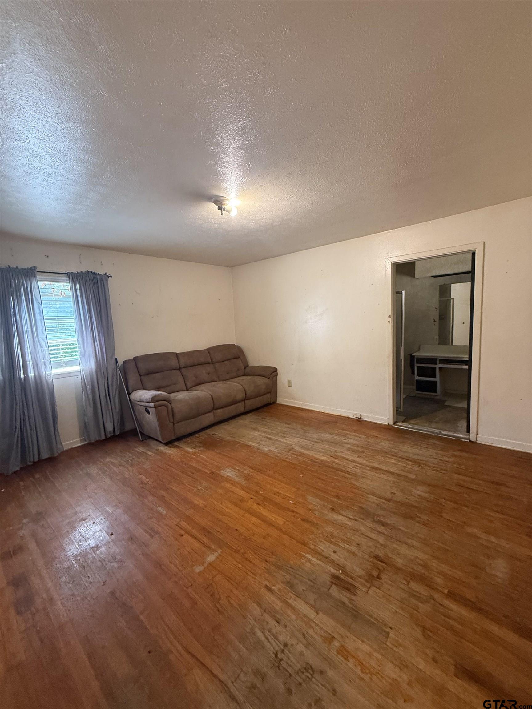 200 East Scenic Loop Hawkins, TX 75765 - Photo 12 of 17 a view of an empty room with window and wooden floor