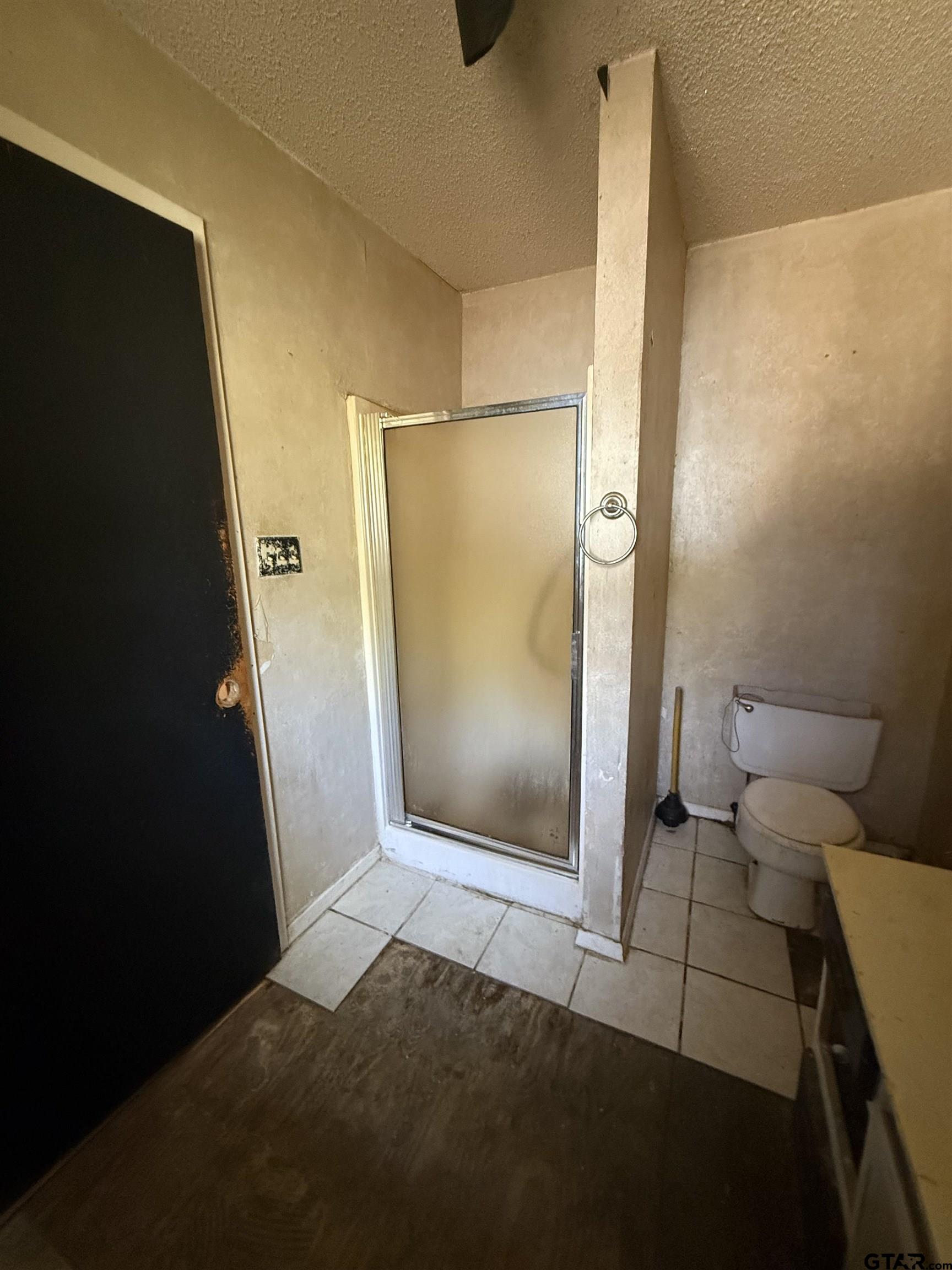 200 East Scenic Loop Hawkins, TX 75765 - Photo 14 of 17 a bathroom with a granite countertop shower and a toilet