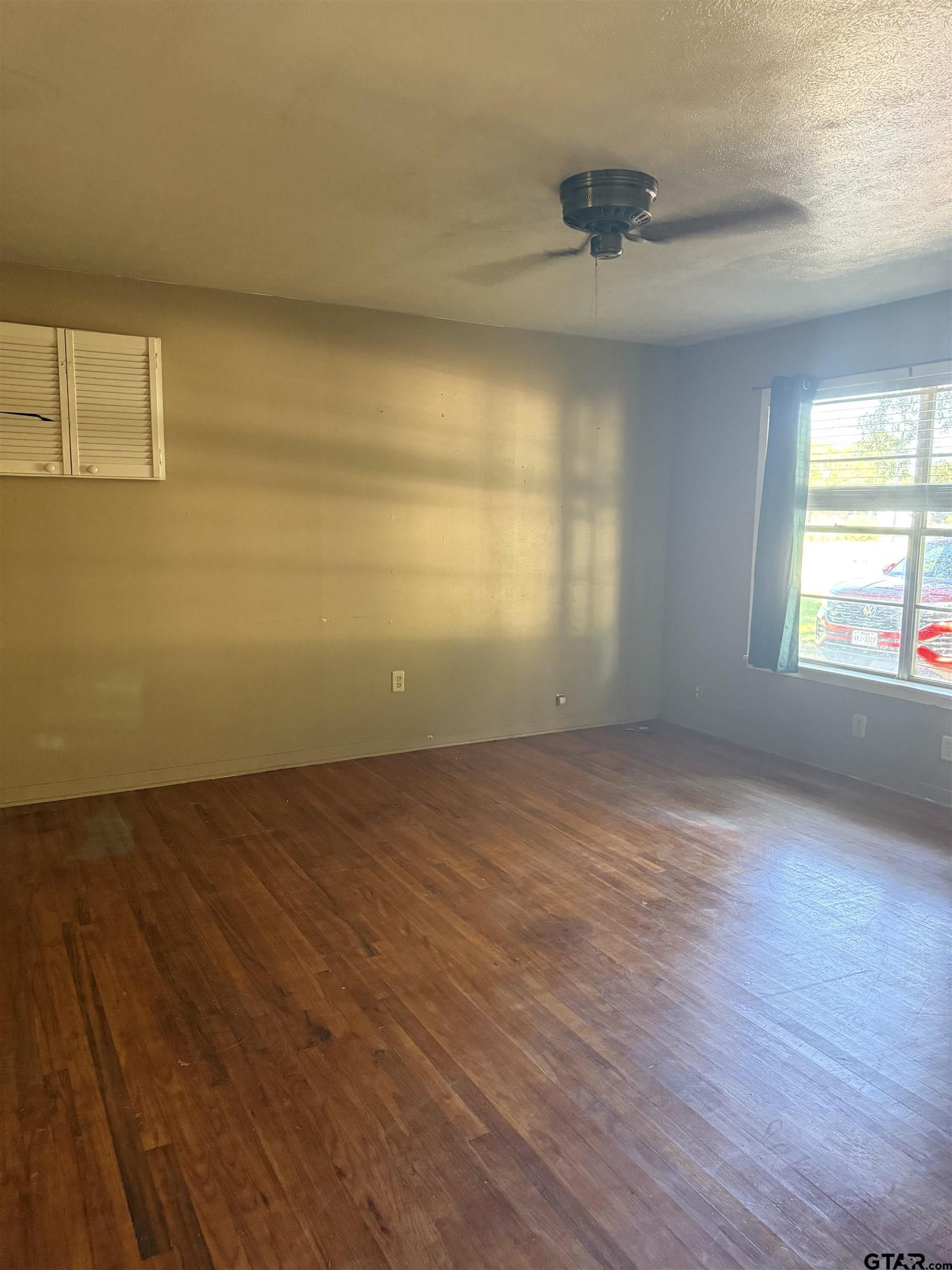 200 East Scenic Loop Hawkins, TX 75765 - Photo 2 of 17 wooden floor in an empty room with a window
