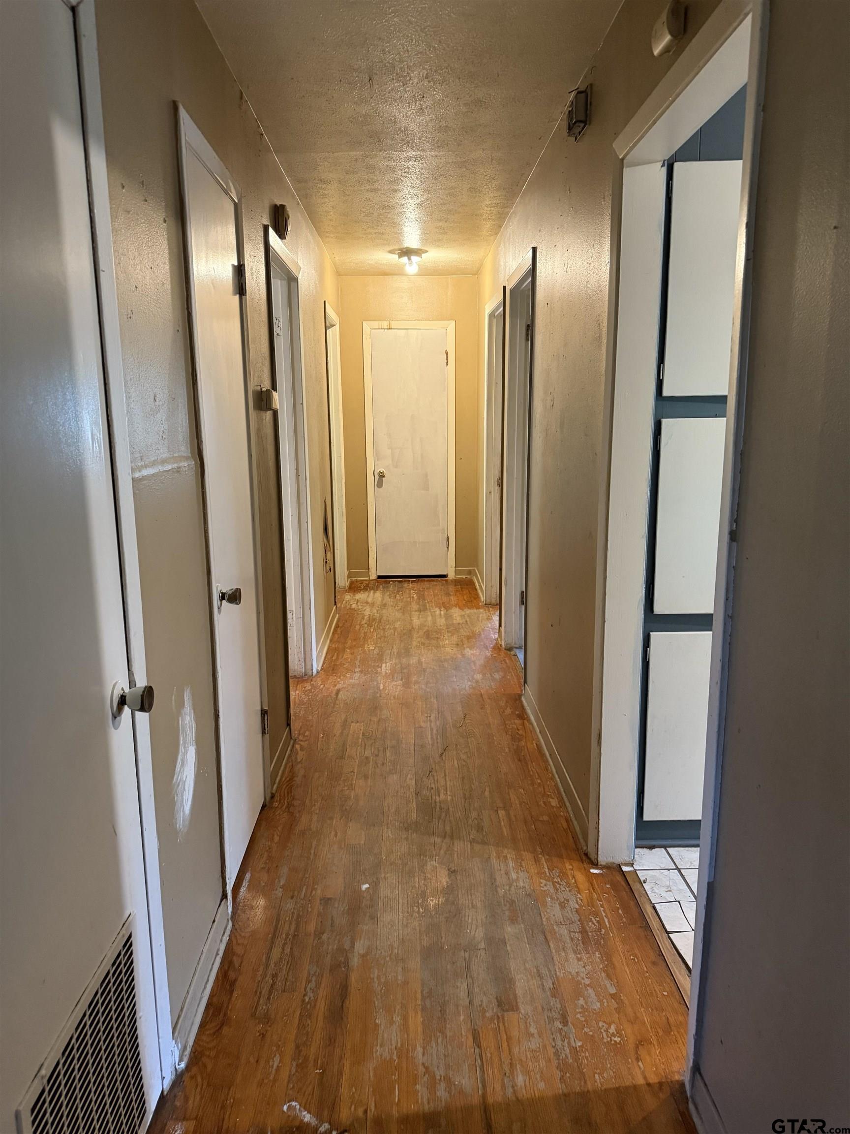 200 East Scenic Loop Hawkins, TX 75765 - Photo 7 of 17 a view of a hallway with wooden floor and staircase