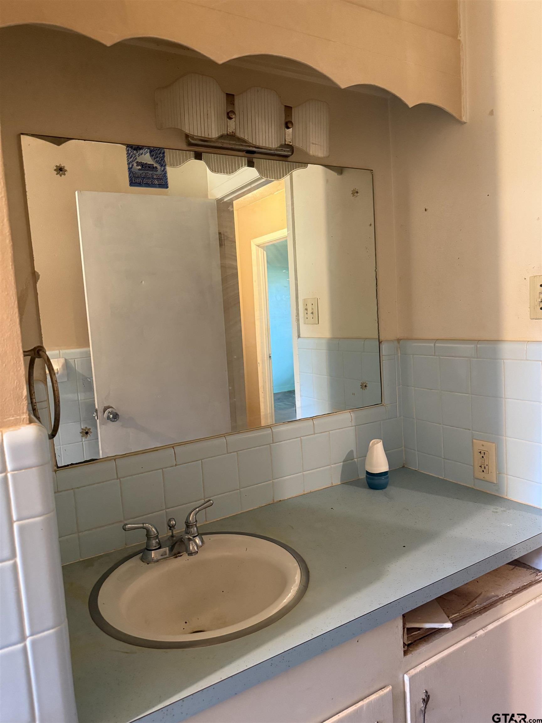 200 East Scenic Loop Hawkins, TX 75765 - Photo 10 of 17 a bathroom with a sink and a mirror