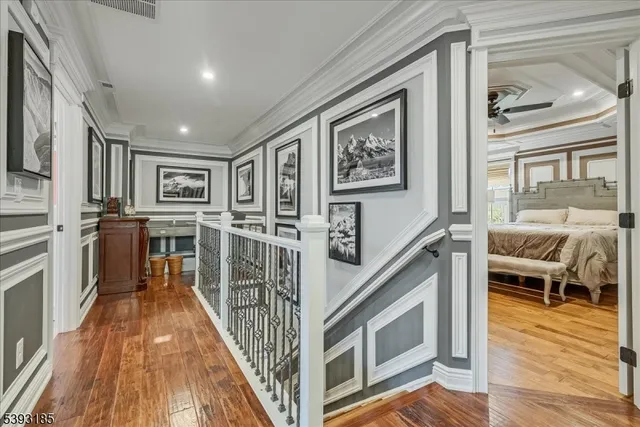 a view of a hallway with wooden floor and staircase
