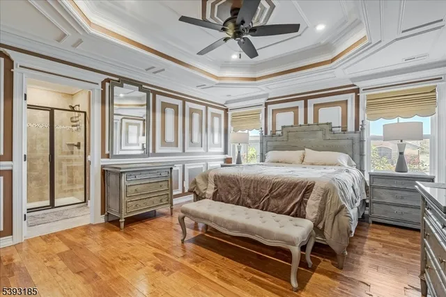 a bedroom with a bed dresser and a large window
