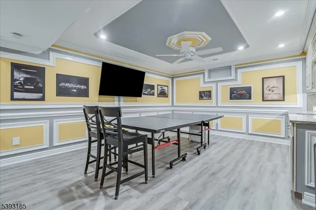 a view of a dining room with furniture and a flat screen tv