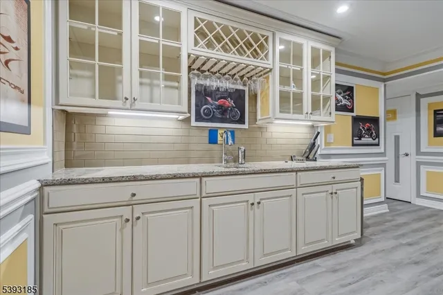 a kitchen with stainless steel appliances granite countertop a sink and a wooden cabinets