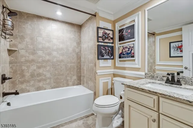 a bathroom with a granite countertop sink a toilet and bathtub