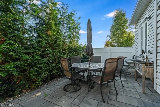 a view of a backyard with furniture and a garden