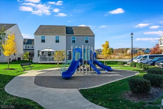 a view of outdoor space with playground and green space