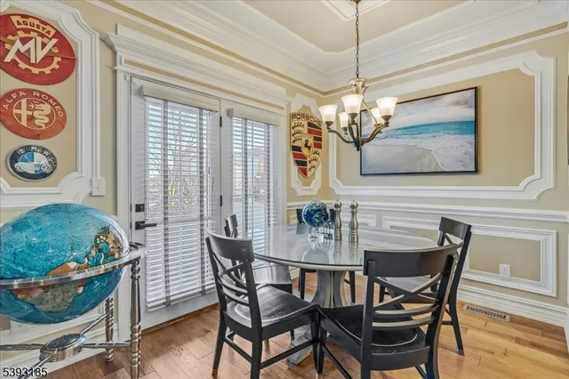 a view of a dining room with furniture and chandelier