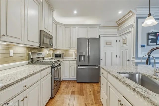 a kitchen with a refrigerator sink and cabinets