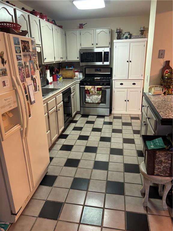 100 Denniston Street, Unit 59 Pittsburgh, PA 15206 - Photo 12 of 24 a kitchen with granite countertop a stove a sink and a refrigerator