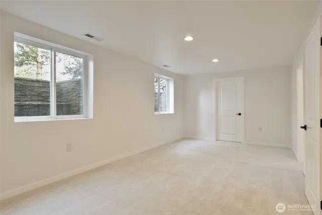 a bathroom with a granite countertop double vanity sink and a mirror