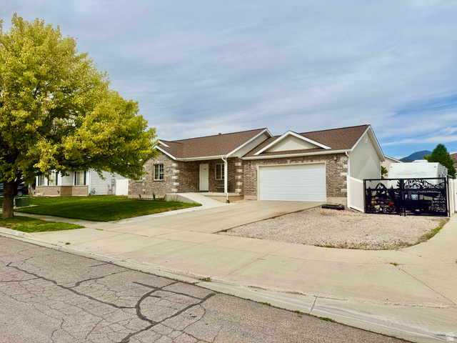 1353 360 West Payson, UT 84651 - Photo 2 of 16 Ranch-style residence featuring a brick facade and an attached two-car garage