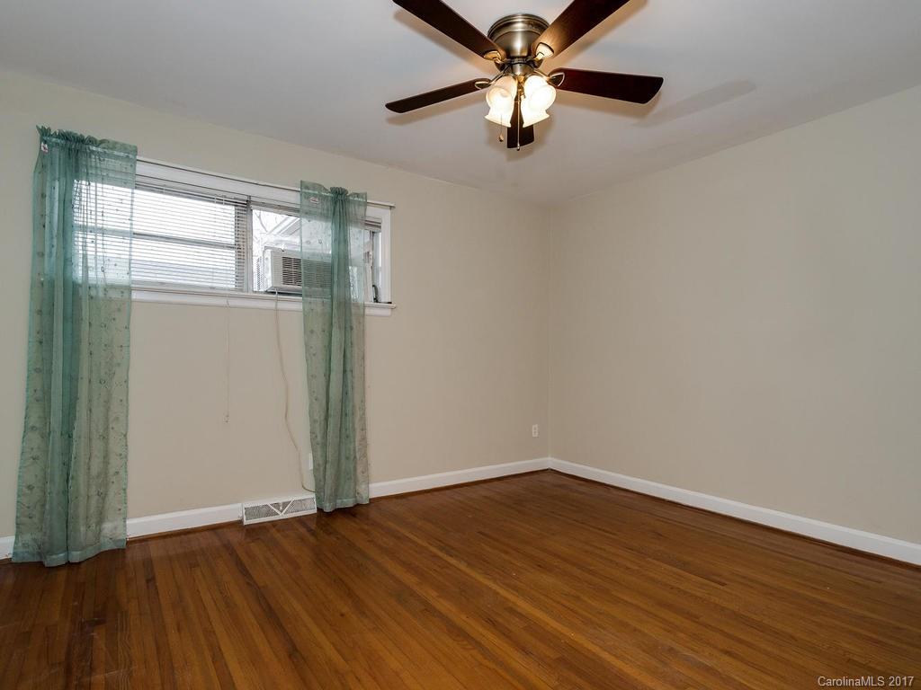 4315 Walker Road Charlotte, NC 28211 - Photo 12 of 14 an empty room with wooden floor fan and windows
