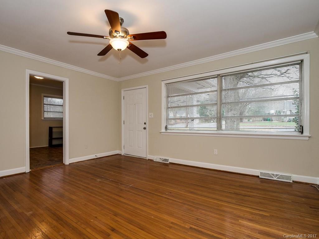 4315 Walker Road Charlotte, NC 28211 - Photo 5 of 14 a view of an empty room with wooden floor and a window