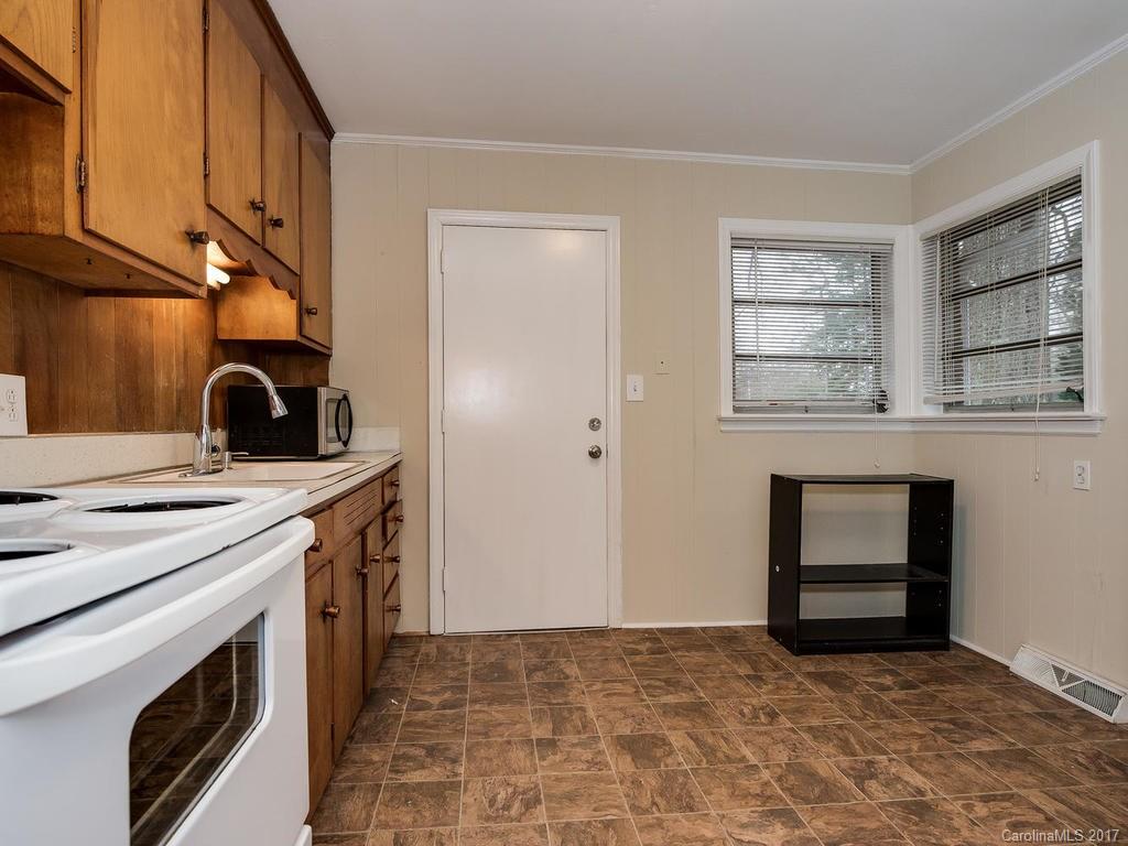 4315 Walker Road Charlotte, NC 28211 - Photo 6 of 14 a kitchen with a stove and a cabinet