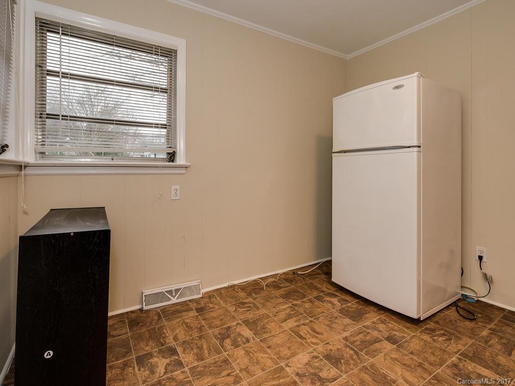 4315 Walker Road Charlotte, NC 28211 - Photo 8 of 14 a view of a kitchen with wooden floor and a refrigerator