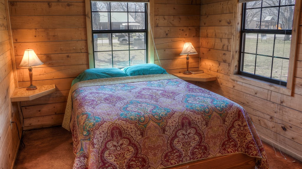 98 Red Wright Road Rio Frio, TX 78879 - Photo 12 of 44 a bed sitting in a bedroom next to a window