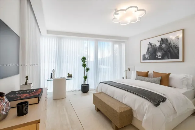 a bedroom with a bed and a chandelier