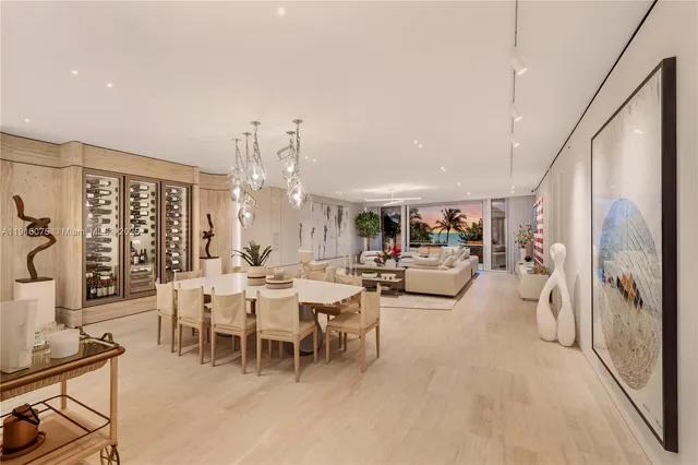 a living room with furniture a chandelier and a large window