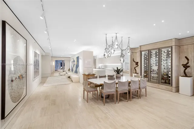 a living room with furniture a chandelier and a large window