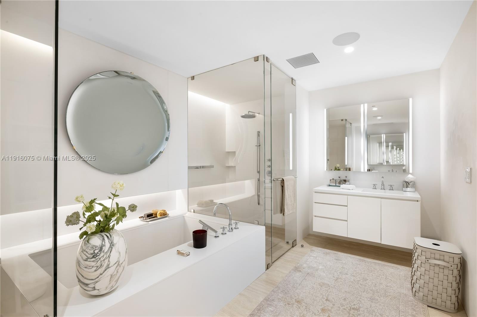 9001 Collins Avenue, Unit S207 Surfside, FL 33154 - Photo 9 of 14 a spacious bathroom with a granite countertop tub sink and mirror