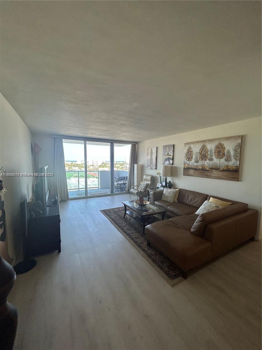 1200 West Avenue, Unit 1008 Miami Beach, FL 33139 - Photo 4 of 17 a living room with furniture and a large window