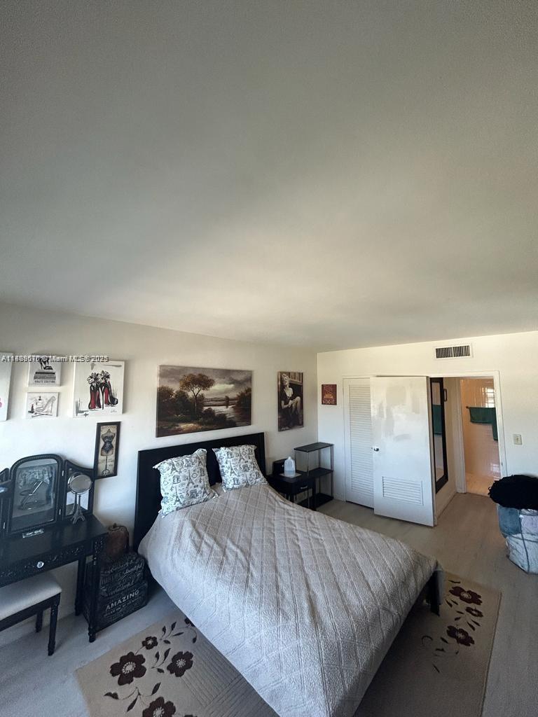 1200 West Avenue, Unit 1008 Miami Beach, FL 33139 - Photo 7 of 17 a bedroom with a large bed and a dresser