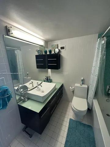 a bathroom with a sink toilet and mirror