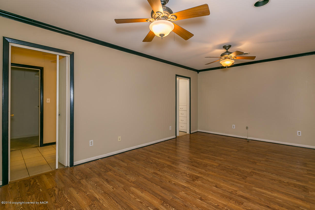 6107 Elmhurst Road Amarillo, TX 79106 - Photo 15 of 32 a view of an empty room with window and wooden floor