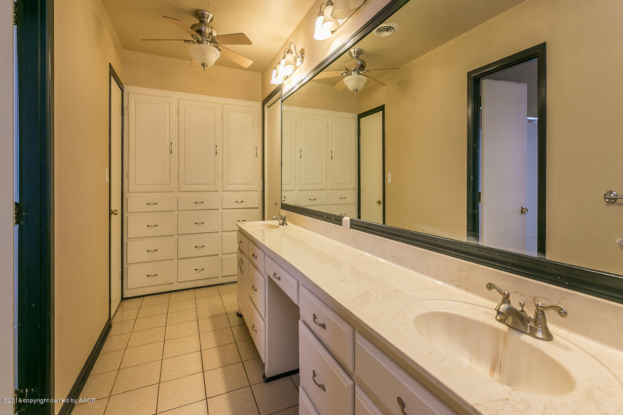 6107 Elmhurst Road Amarillo, TX 79106 - Photo 16 of 32 a spacious bathroom with a granite countertop sink and a mirror