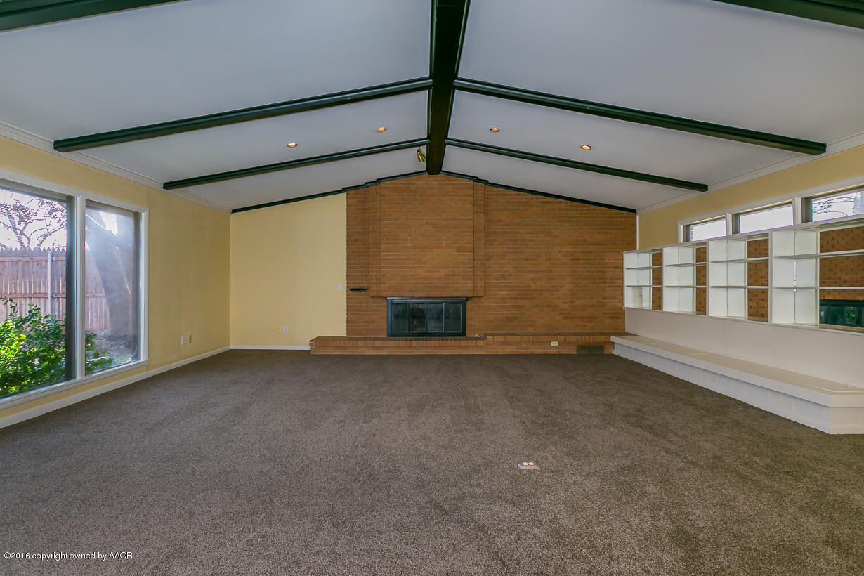 6107 Elmhurst Road Amarillo, TX 79106 - Photo 5 of 32 a view of an empty room with a window