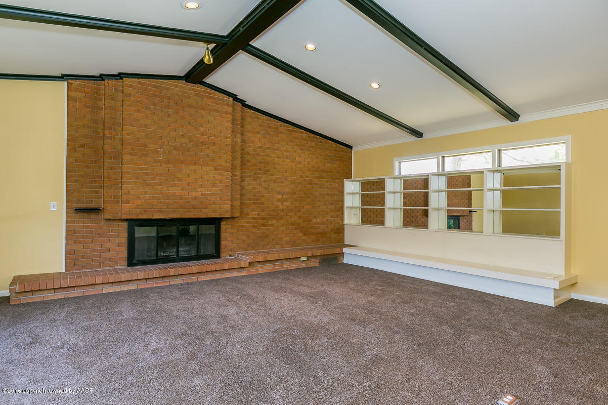 6107 Elmhurst Road Amarillo, TX 79106 - Photo 6 of 32 a view of an empty room with a fireplace