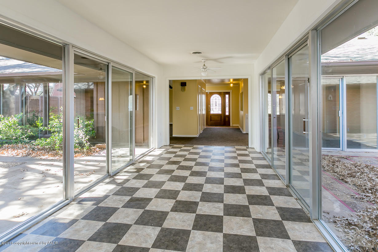 6107 Elmhurst Road Amarillo, TX 79106 - Photo 8 of 32 a view of a entryway with a rug floor and glass door