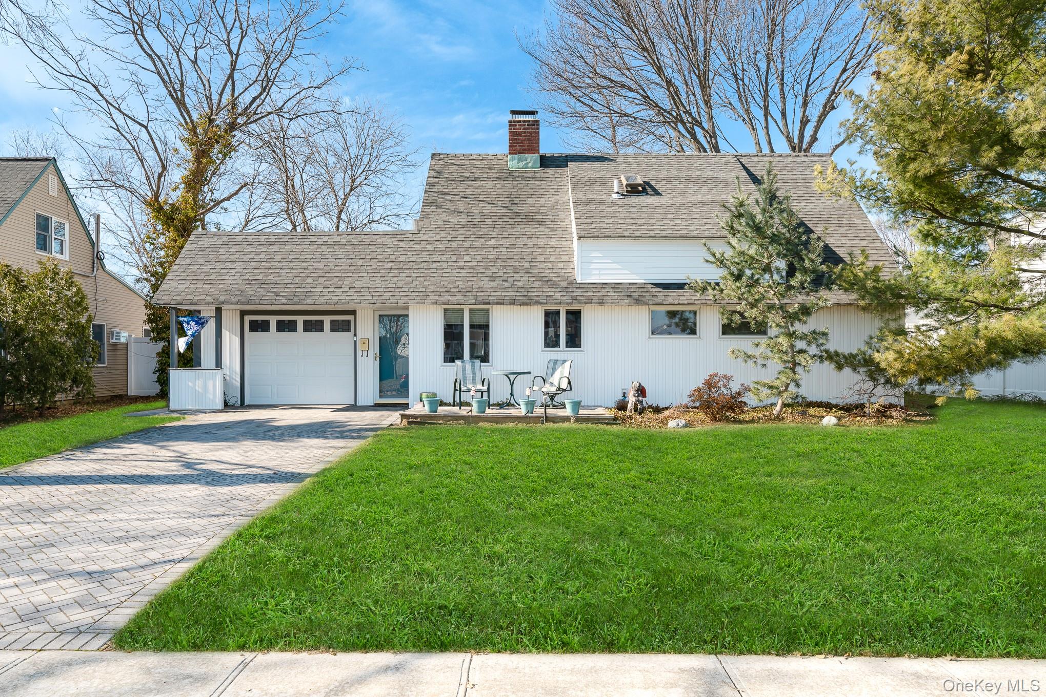44 Disc Lane Wantagh, NY 11793 - Photo 1 of 26 a view of a white house with a big yard and large tree