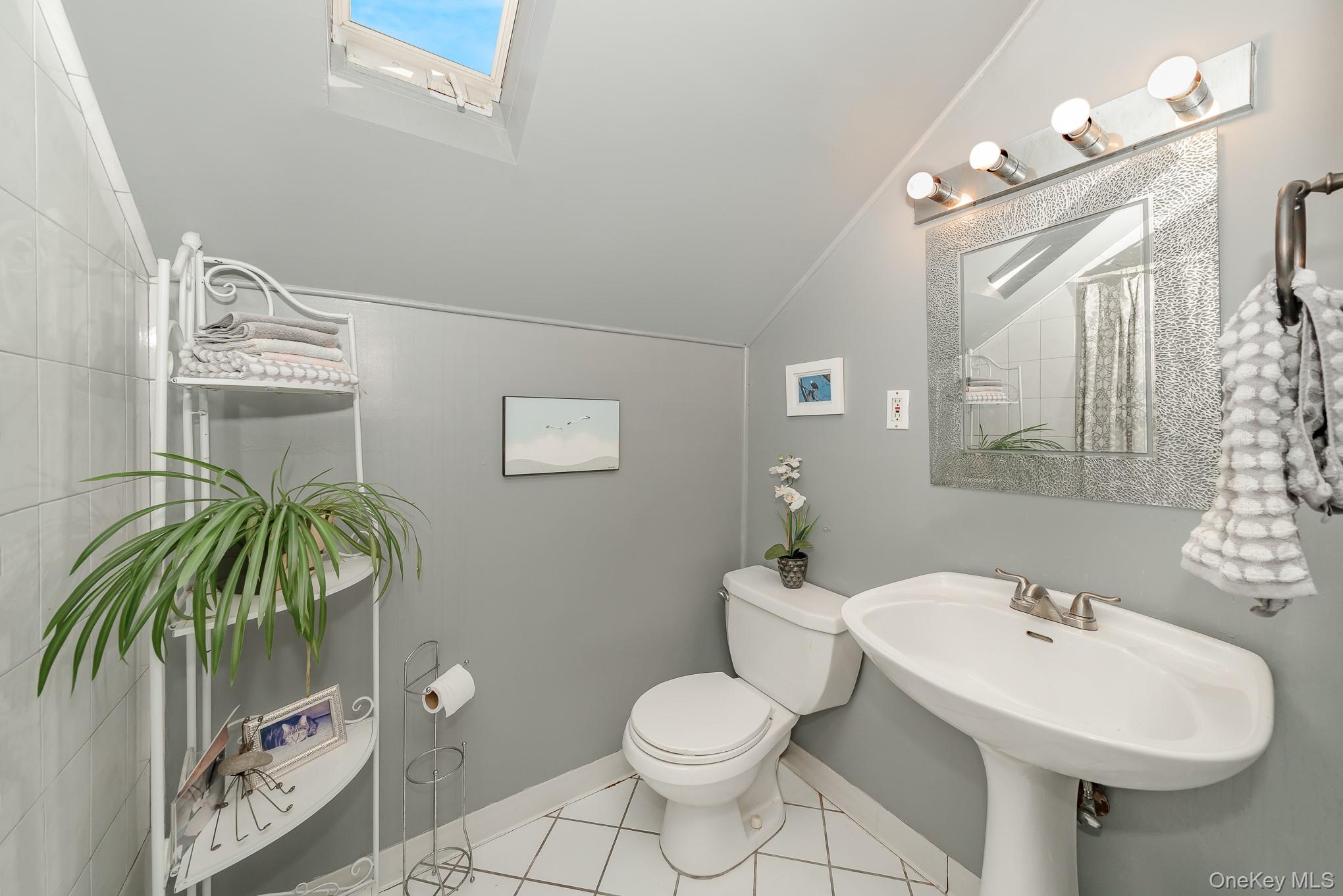 44 Disc Lane Wantagh, NY 11793 - Photo 16 of 26 a bathroom with a toilet sink and mirror