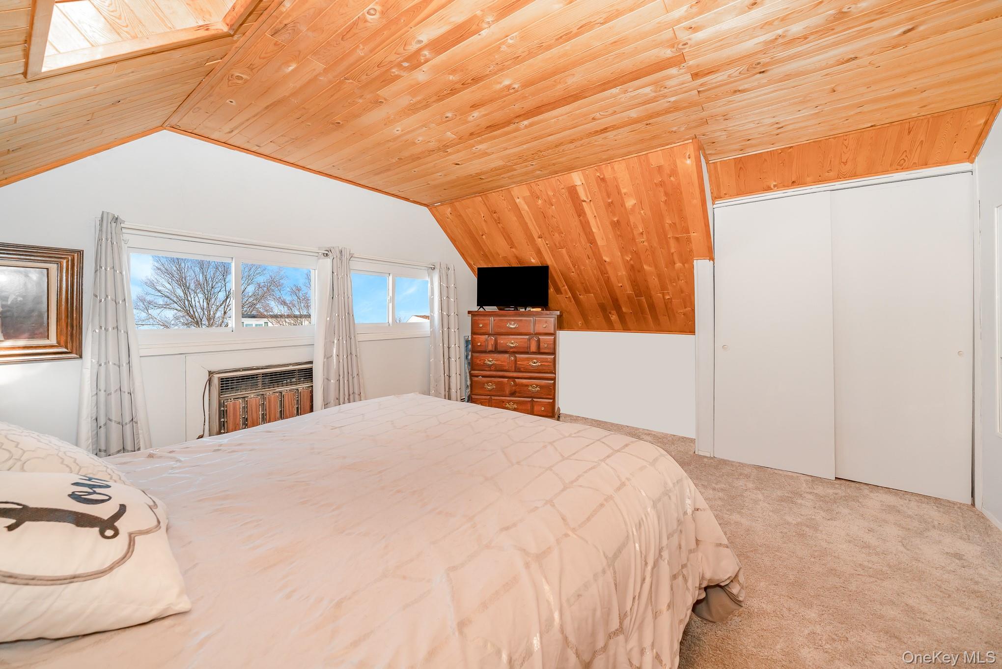 44 Disc Lane Wantagh, NY 11793 - Photo 18 of 26 a bedroom with a bed and a fireplace