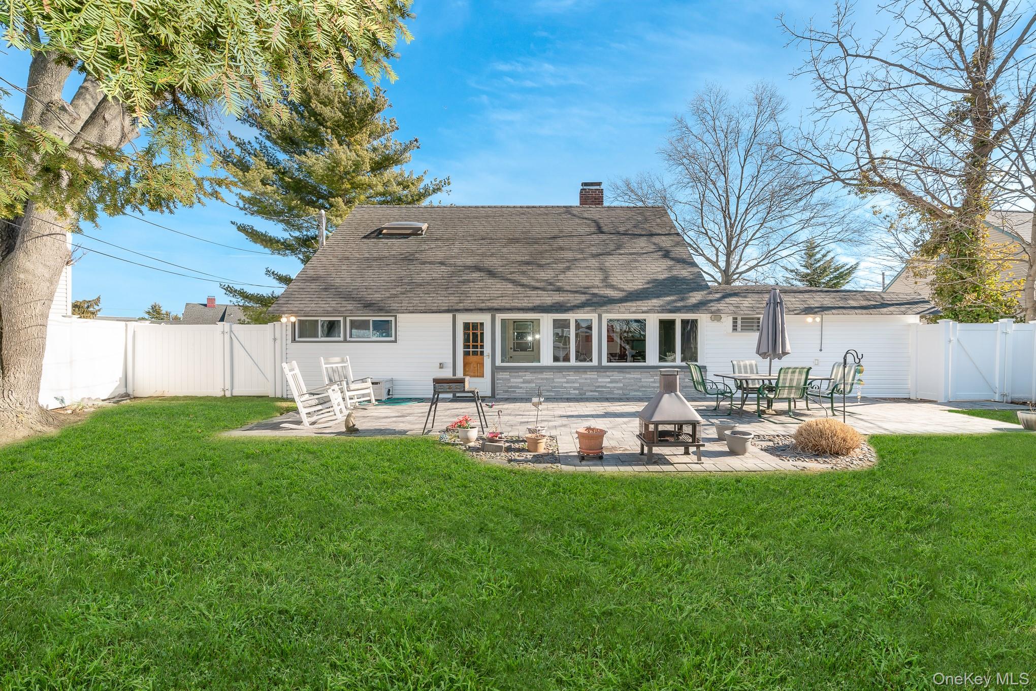 44 Disc Lane Wantagh, NY 11793 - Photo 19 of 26 a front view of a house with patio and yard