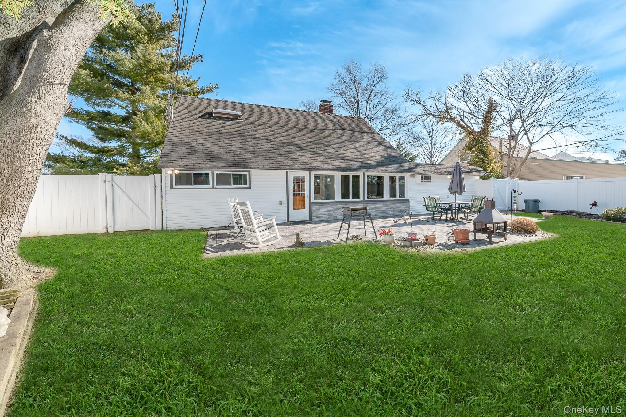 44 Disc Lane Wantagh, NY 11793 - Photo 20 of 26 a front view of a house with patio and garden