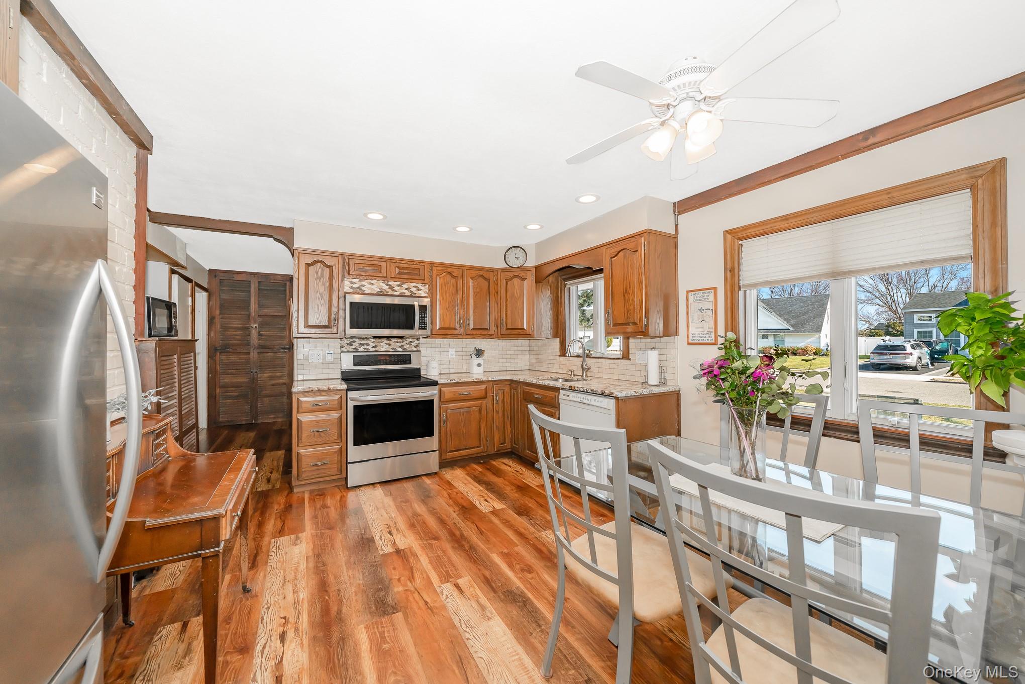44 Disc Lane Wantagh, NY 11793 - Photo 5 of 26 a kitchen with a sink stainless steel appliances and counter top space
