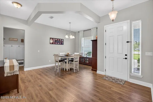a living room with a baby crib dresser and a window