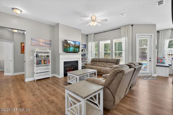 a living room with furniture and a wooden floor