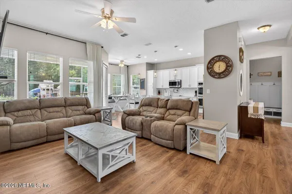 a kitchen with stainless steel appliances granite countertop a stove top oven a sink a stove a dining table and chairs