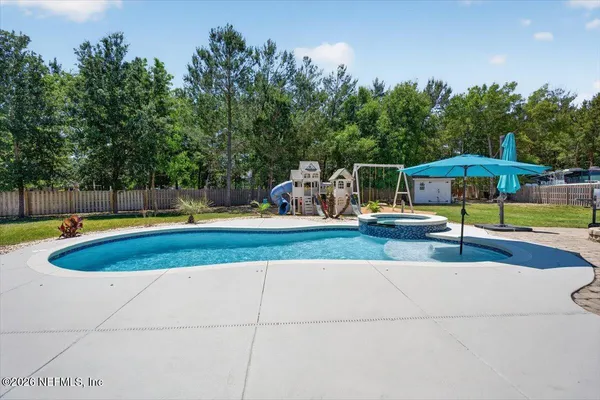 an aerial view of a house with yard swimming pool and outdoor seating